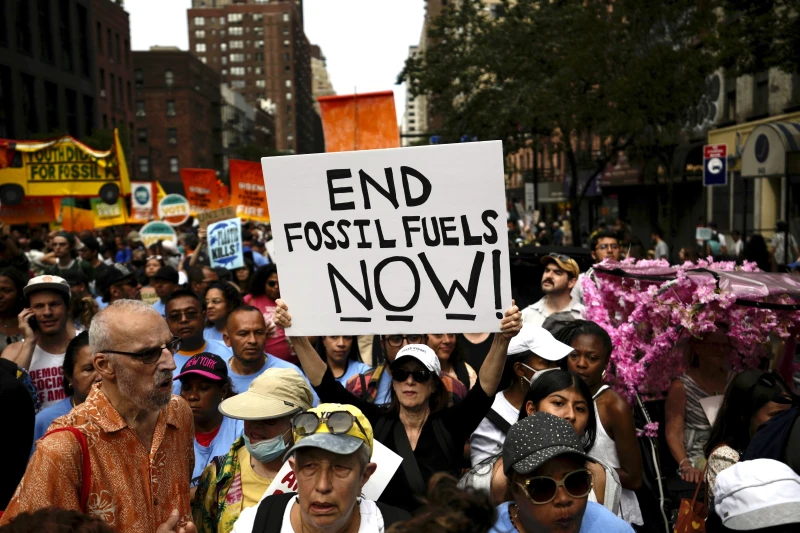 Tens of thousands march to kick off climate summit, demanding end to warming-causing fossil fuels