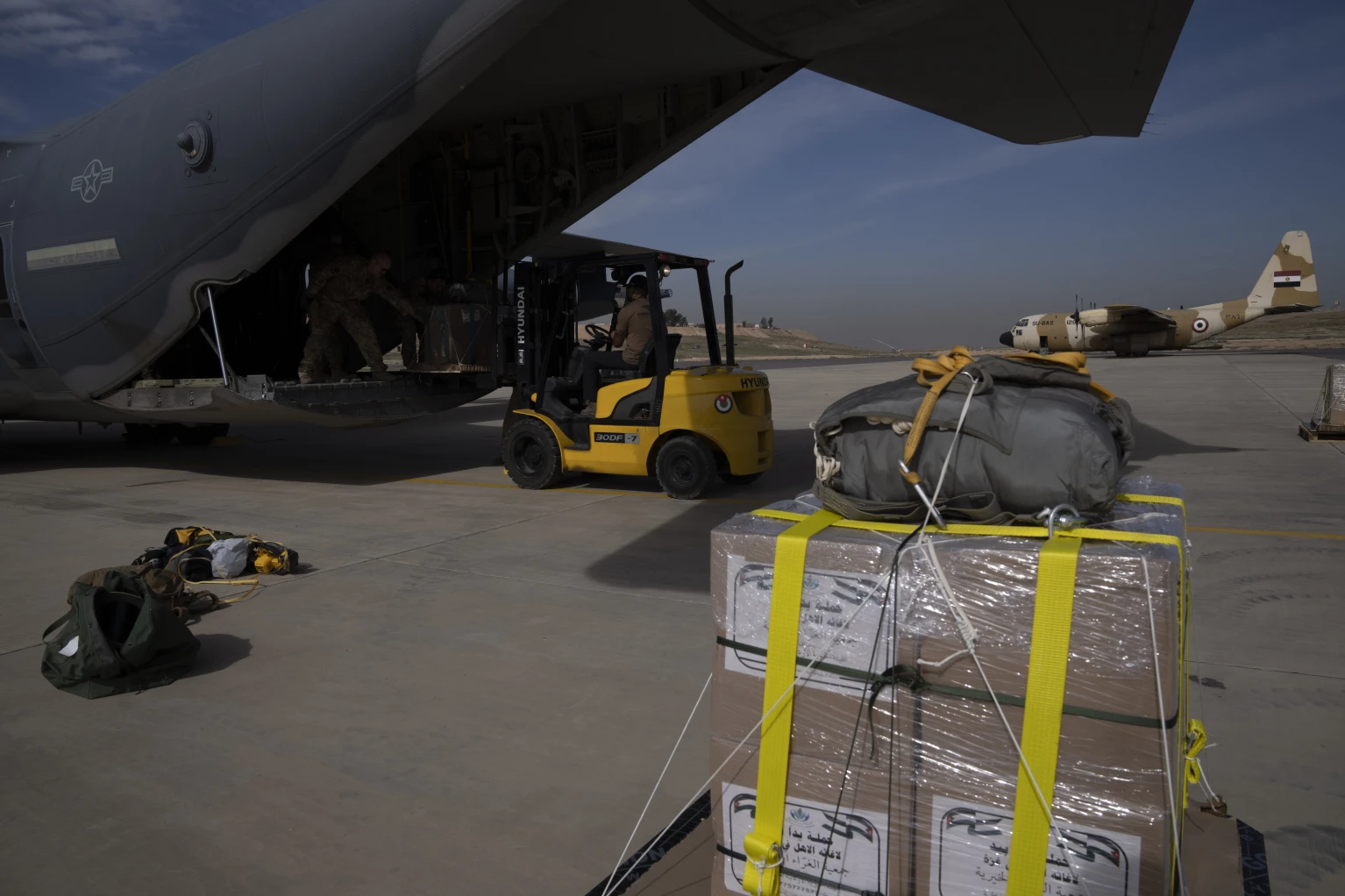 From a US military plane, airdrops bring small doses of aid to Gaza, levelled by war