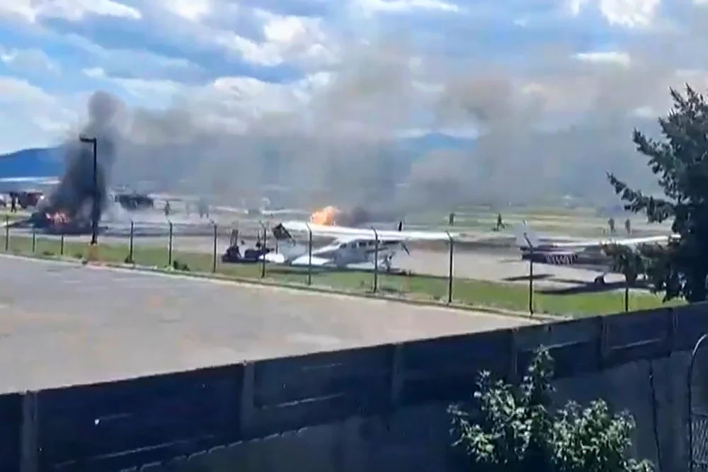 Plane crashes into parked aircraft while landing at Montana airport, sparking fire