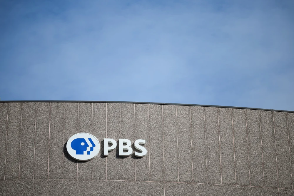 PBS says it has cut about 100 positions because of loss of federal funding
