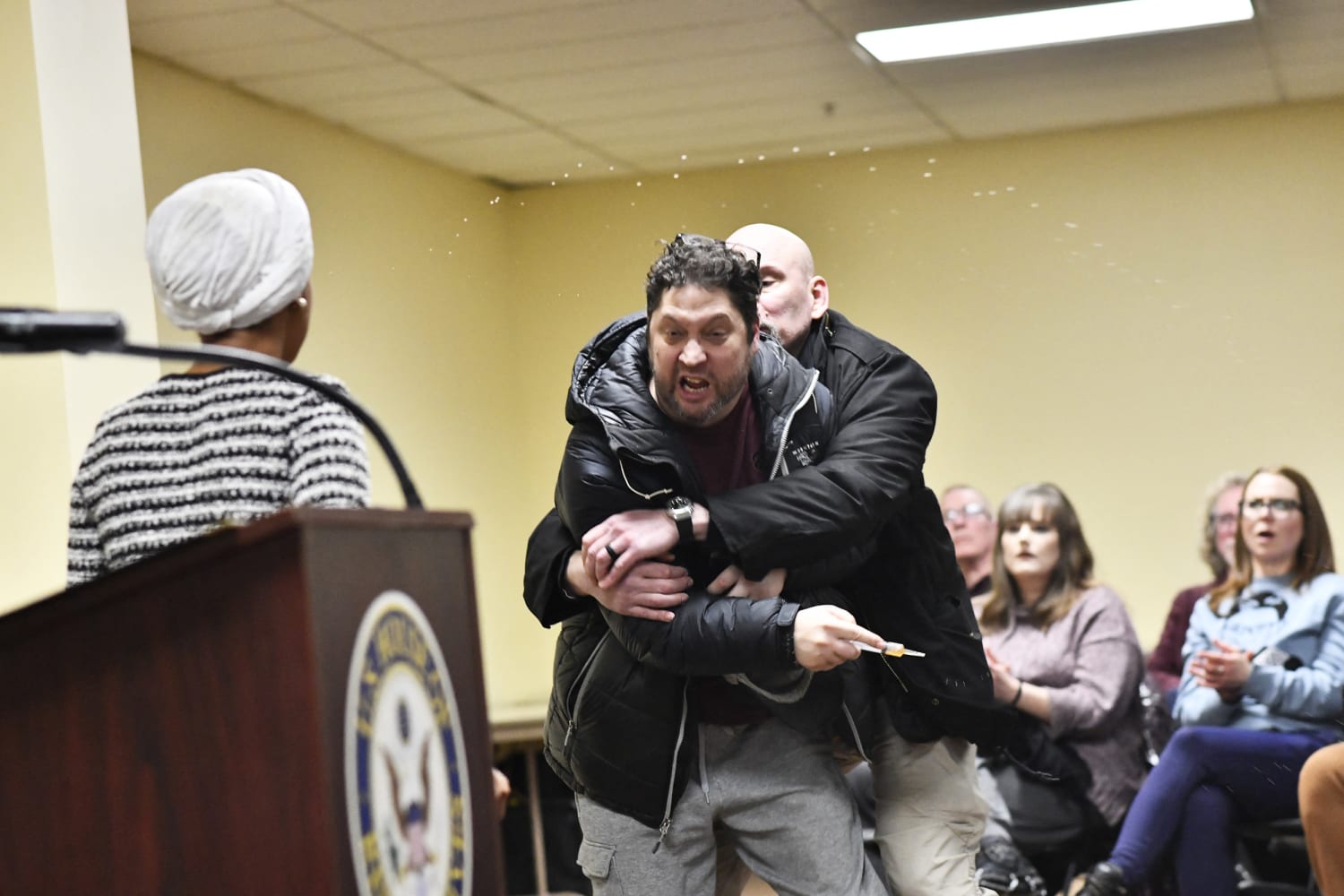 Man lunges at Rep. Ilhan Omar during town hall and tries to spray her with unknown substance