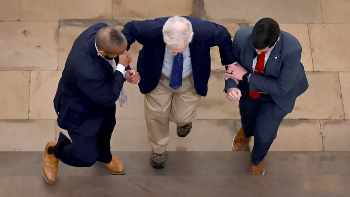 Mitch McConnell swarmed by security as reporter pleads: ‘Can you say a word for us?’